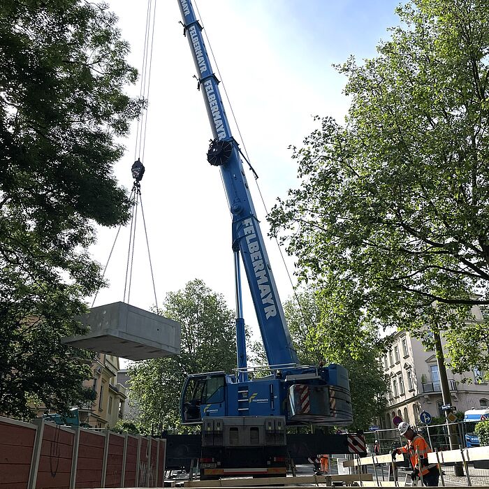 Einbau Muffenbauwerk Kran mit Betonbauteilen beim Einheben