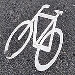 Blick auf die Bautzner Straße stadteinwärts, Fahrradfahrer befährt Fahrradstreifen, Fahrzeug wartet an einer Einmündung zum Einbiegen in die Straße