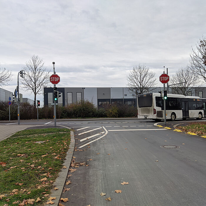 Linienbus biegt an einer Ampelkreuzung bei grün rechts ab